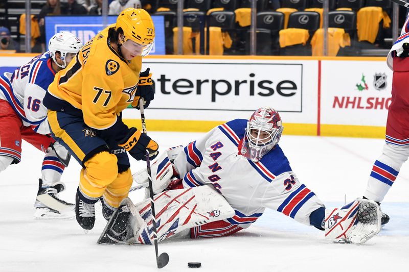 Dec 2, 2023; Nashville, Tennessee, USA; New York Rangers goaltender Igor Shesterkin (31) lays on the ice to block a shot attempt by Nashville Predators right wing Luke Evangelista (77) during the first period at Bridgestone Arena. Mandatory Credit: Christopher Hanewinckel-USA TODAY Sports