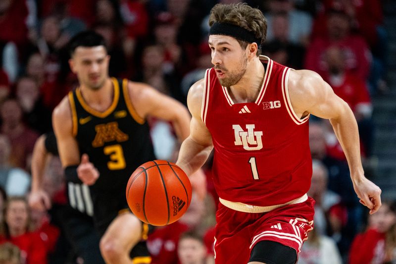 Feb 25, 2024; Lincoln, Nebraska, USA; Nebraska Cornhuskers guard Sam Hoiberg (1) dribbles the ball against Minnesota Golden Gophers forward Dawson Garcia (3) during the first half at Pinnacle Bank Arena. Mandatory Credit: Dylan Widger-USA TODAY Sports