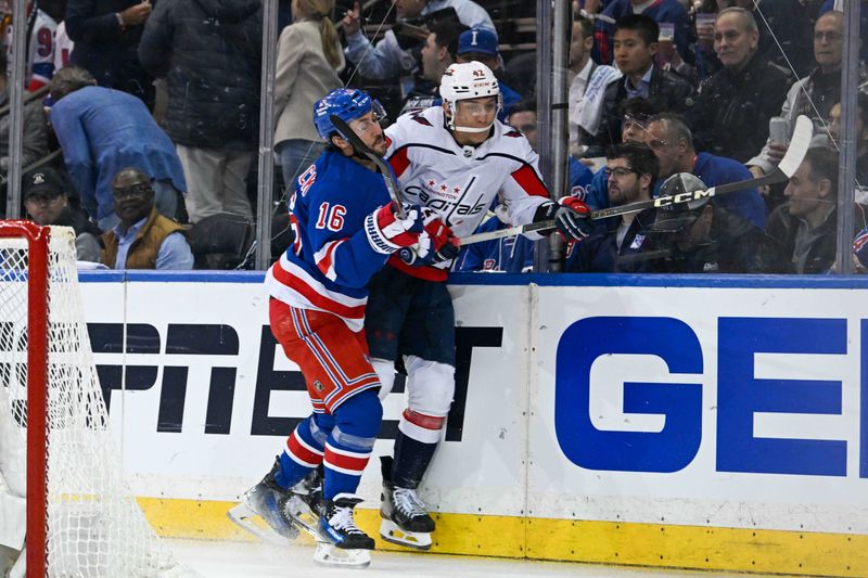 Apr 23, 2024; New York, New York, USA;  New York Rangers center Vincent Trocheck (16) checks Washington Capitals defenseman Martin Fehervary (42) into the boards during the first period in game two of the first round of the 2024 Stanley Cup Playoffs at Madison Square Garden. Mandatory Credit: Dennis Schneidler-USA TODAY Sports