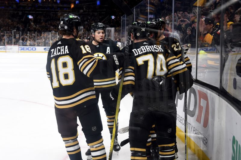 Jan 18, 2024; Boston, Massachusetts, USA; Boston Bruins center Pavel Zacha (18) left wing Jake DeBrusk (74) celebrate a goal by right wing David Pastrnak (88 (right) during the third period against the Colorado Avalanche at TD Garden. Mandatory Credit: Bob DeChiara-USA TODAY Sports