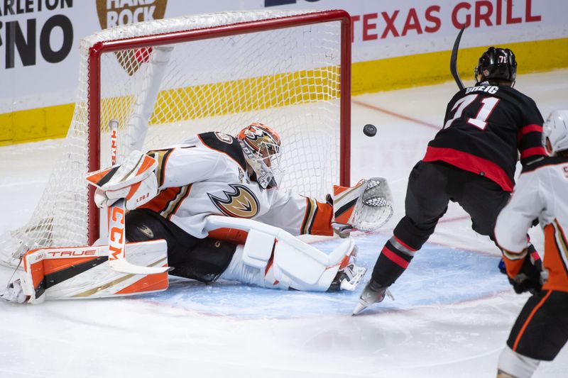 Feb 15, 2024; Ottawa, Ontario, CAN; Ottawa Senators center Ridly Greig (71) shoots wide on a shot towards Anaheim Ducks goalie Lukas Dostal (1) in the third period at the Canadian Tire Centre. Mandatory Credit: Marc DesRosiers-USA TODAY Sports