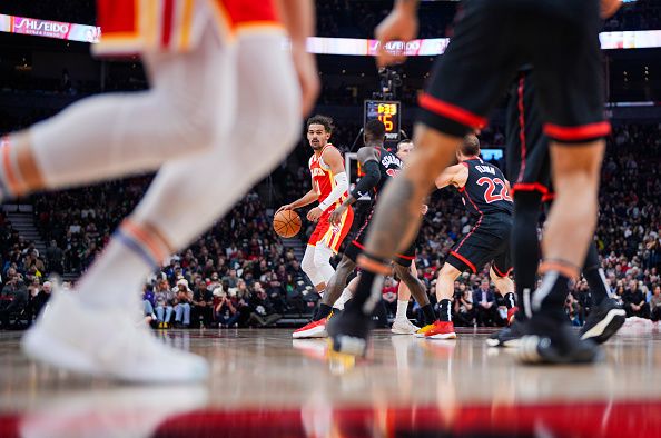 TORONTO, ON - DECEMBER 15: Trae Young #11 of the Atlanta Hawks dribbles against the Toronto Raptors during the first half of their basketball game at the Scotiabank Arena on December 15, 2023 in Toronto, Ontario, Canada. NOTE TO USER: User expressly acknowledges and agrees that, by downloading and/or using this Photograph, user is consenting to the terms and conditions of the Getty Images License Agreement. (Photo by Mark Blinch/Getty Images)