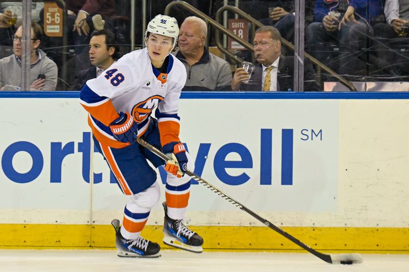 Jan 29, 2026; New York, New York, USA;  New York Islanders defenseman Matthew Schaefer (48) skates with the puck against the New York Rangers during the first period at Madison Square Garden. Mandatory Credit: Dennis Schneidler-Imagn Images