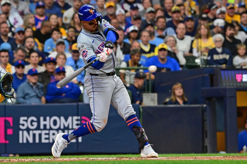 Oct 1, 2024; Milwaukee, Wisconsin, USA; New York Mets third base Mark Vientos (27) hits a single against the Milwaukee Brewers during the second inning in game one of the Wildcard round for the 2024 MLB Playoffs at American Family Field. Mandatory Credit: Benny Sieu-Imagn Images
