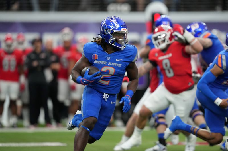 Dec 2, 2023; Las Vegas, NV, USA; Boise State Broncos running back Ashton Jeanty (2) carries the ball against the UNLV Rebels in the first half during the Mountain West Championship at Allegiant Stadium. Mandatory Credit: Kirby Lee-USA TODAY Sports