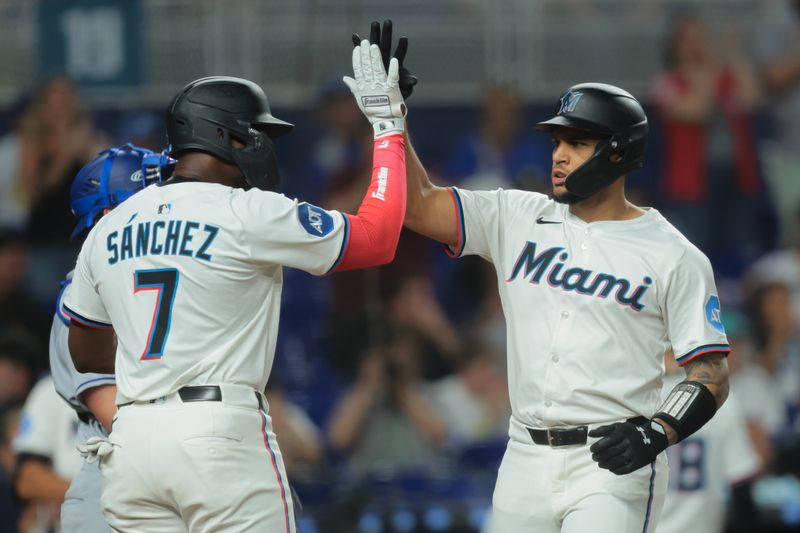 May 5, 2025; Miami, Florida, USA; Miami Marlins catcher Agustin Ramirez (50) celebrates with right fielder Jesus Sanchez (7) after hitting a three-run home run against the Los Angeles Dodgers during the eighth inning at loanDepot Park. Mandatory Credit: Sam Navarro-Imagn Images