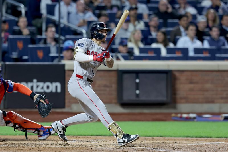 Sep 4, 2024; New York City, New York, USA; Boston Red Sox center fielder Jarren Duran (16) follows through on an RBI double against the New York Mets during the third inning at Citi Field. Mandatory Credit: Brad Penner-Imagn Images