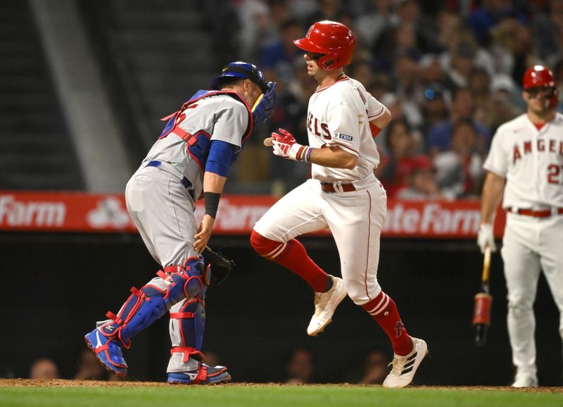 Jun 8, 2023; Anaheim, California, USA;  Los Angeles Angels shortstop Zach Neto (9) scores a run on a throwing error by Chicago Cubs catcher Yan Gomes (15) in the sixth inning at Angel Stadium. Mandatory Credit: Jayne Kamin-Oncea-USA TODAY Sports