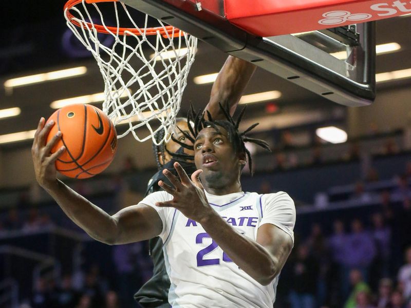 Jan 6, 2024; Manhattan, Kansas, USA; Kansas State Wildcats forward Arthur Maluma (24) goes to the basket against UCF Knights forward Omar Payne (5) during the first half at Bramlage Coliseum. Mandatory Credit: Scott Sewell-USA TODAY Sports