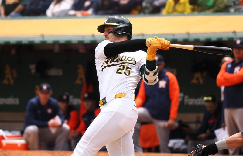 May 25, 2024; Oakland, California, USA; Oakland Athletics designated hitter Brent Rooker (25) hits an two-run RBI double against the Houston Astros during the first inning at Oakland-Alameda County Coliseum. Mandatory Credit: Kelley L Cox-USA TODAY Sports