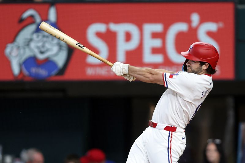 Jun 18, 2024; Arlington, Texas, USA; Texas Rangers third base Josh Smith (8) hits a single in the first inning against the New York Mets at Globe Life Field. Mandatory Credit: Tim Heitman-USA TODAY Sports