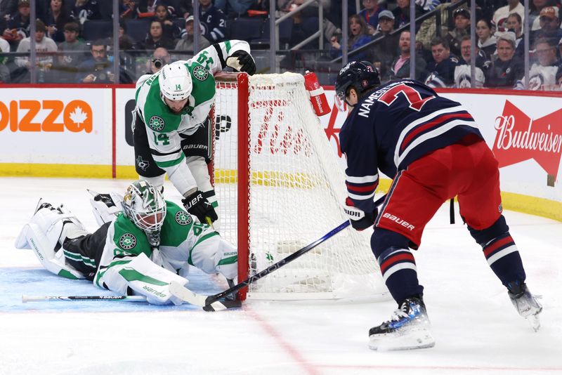 Nov 9, 2024; Winnipeg, Manitoba, CAN; Winnipeg Jets center Vladislav Namestnikov (7) scores on Dallas Stars goaltender Jake Oettinger (29) in the second period at Canada Life Centre. Mandatory Credit: James Carey Lauder-Imagn Images
