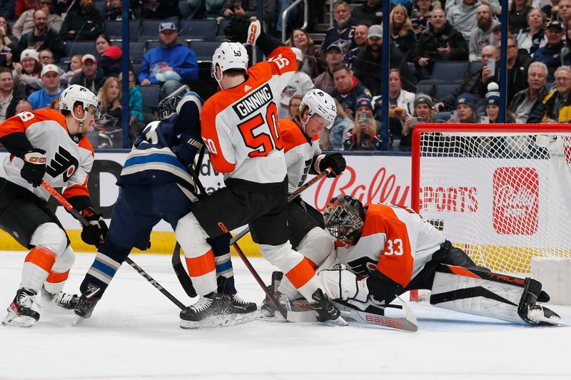 Apr 6, 2024; Columbus, Ohio, USA; Philadelphia Flyers goalie Samuel Ersson (33) makes a save as Columbus Blue Jackets left wing Johnny Gaudreau (13) looks for a rebound during the first period at Nationwide Arena. Mandatory Credit: Russell LaBounty-USA TODAY Sports