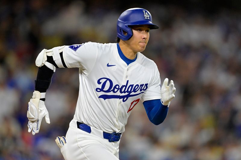 Jun 21, 2024; Los Angeles, California, USA;  Los Angeles Dodgers designated hitter Shohei Ohtani (17) runs out an infield hit in the eighth inning against the Los Angeles Angels at Dodger Stadium. Mandatory Credit: Jayne Kamin-Oncea-USA TODAY Sports