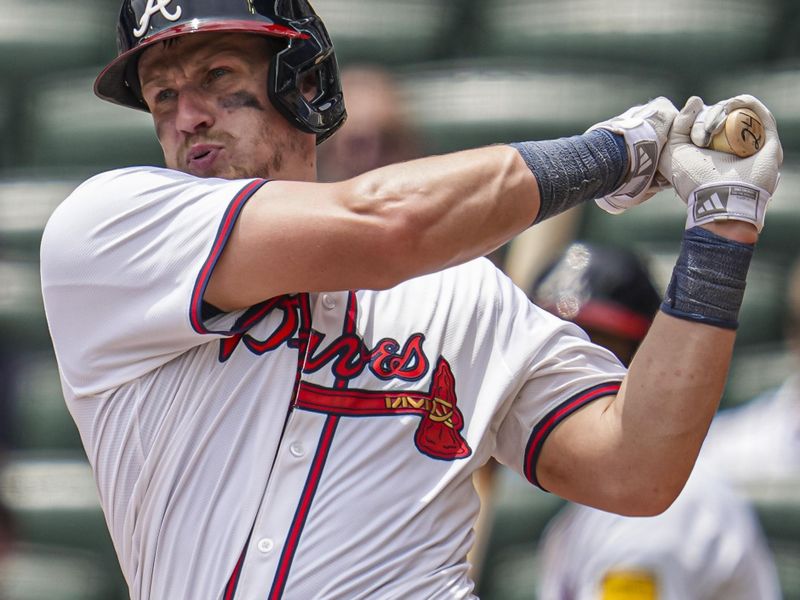 Jun 19, 2024; Cumberland, Georgia, USA; Atlanta Braves catcher Sean Murphy (12) hits a single against the Detroit Tigers during the seventh inning at Truist Park. Mandatory Credit: Dale Zanine-USA TODAY Sports