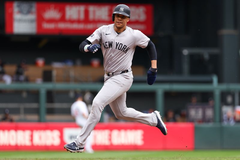 May 16, 2024; Minneapolis, Minnesota, USA; New York Yankees Juan Soto (22) advances to third on a double hit by designated hitter Aaron Judge (99) during the seventh inning against the Minnesota Twins at Target Field. Mandatory Credit: Matt Krohn-USA TODAY Sports