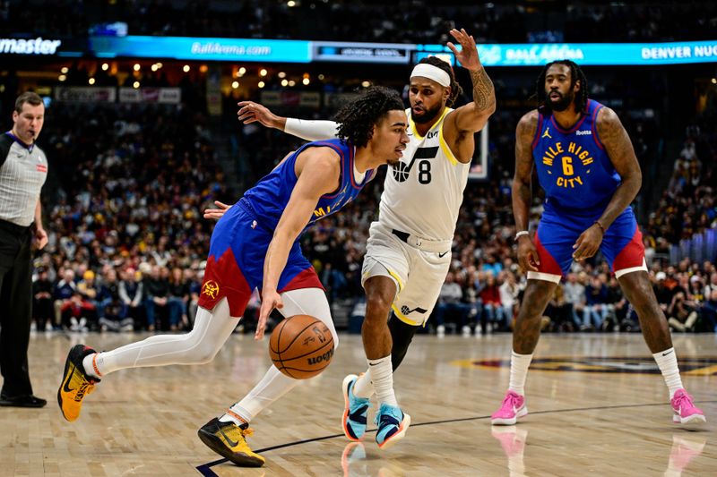 DENVER, COLORADO - NOVEMBER 02: Julian Strawther #3 of the Denver Nuggets is defended by Patty Mills #8 of the Utah Jazz in the first half at Ball Arena on November 2, 2024, 2024 in Denver, Colorado. NOTE TO USER: User expressly acknowledges and agrees that, by downloading and or using this photograph, User is consenting to the terms and conditions of the Getty Images License Agreement. (Photo by Dustin Bradford/Getty Images)