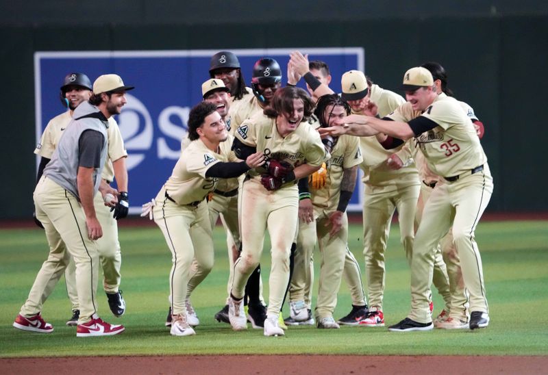 Aug 13, 2024; Phoenix, Arizona, USA; Arizona Diamondbacks outfielder Jake McCarthy (31) celebrates with teammates after hitting a two RBI walk off single against the Colorado Rockies during the ninth inning at Chase Field. Mandatory Credit: Joe Camporeale-USA TODAY Sports