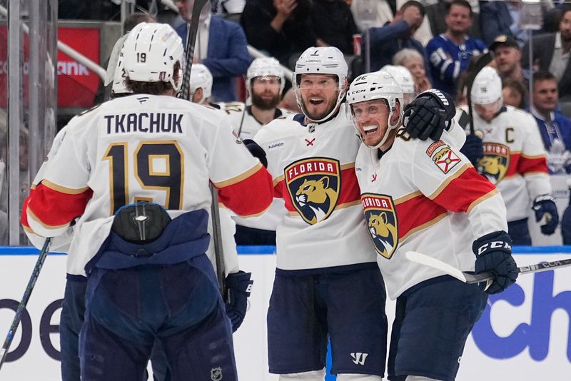 May 14, 2025; Toronto, Ontario, CAN; Florida Panthers defenseman Dmitry Kulikov (7) celebrates his goal against the Toronto Maple Leafs with defenseman Nate Schmidt (88) and forward Matthew Tkachuk (19) during the second period of game five of the second round of the 2025 Stanley Cup Playoffs at Scotiabank Arena. Mandatory Credit: John E. Sokolowski-Imagn Images