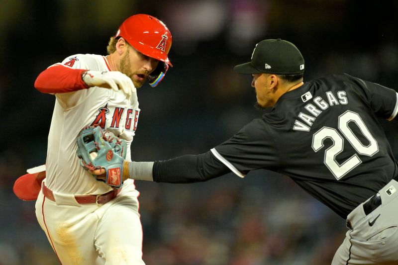 Sep 17, 2024; Anaheim, California, USA;  Los Angeles Angels left fielder Taylor Ward (3) is tagged out by Chicago White Sox third baseman Miguel Vargas (20) in the third inning at Angel Stadium. Mandatory Credit: Jayne Kamin-Oncea-Imagn Images