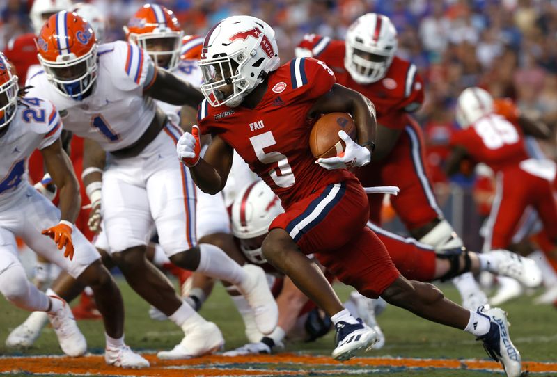 Sep 4, 2021; Gainesville, Florida, USA; Florida Atlantic Owls running back Johnny Ford (5) runs the ball against the Florida Gators during the first quarter at Ben Hill Griffin Stadium. Mandatory Credit: Kim Klement-USA TODAY Sports