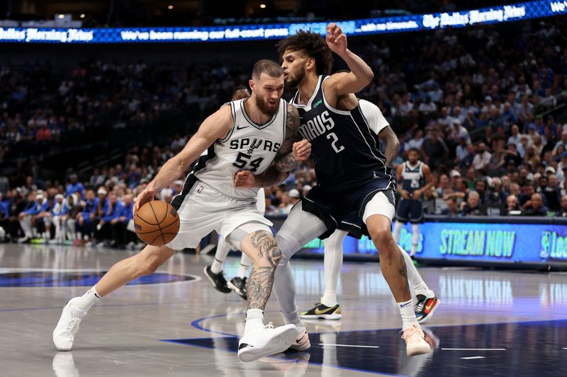 DALLAS, TEXAS - OCTOBER 24: Sandro Mamukelashvili #54 of the San Antonio Spurs drives against Dereck Lively II #2 of the Dallas Mavericks during the fourth quarter at American Airlines Center on October 24, 2024 in Dallas, Texas.  NOTE TO USER: User expressly acknowledges and agrees that, by downloading and or using this photograph, User is consenting to the terms and conditions of the Getty Images License Agreement. The Dallas Mavericks won 120-109. (Photo by Sam Hodde/Getty Images)