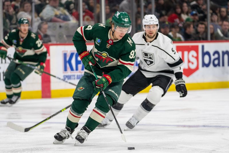 Feb 21, 2023; Saint Paul, Minnesota, USA; Minnesota Wild left wing Kirill Kaprizov (97) controls the puck as Los Angeles Kings right wing Adrian Kempe (9) attacks in the third period at Xcel Energy Center. Mandatory Credit: Matt Blewett-USA TODAY Sports