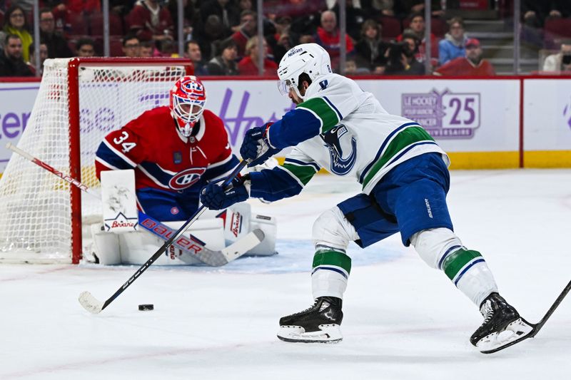 Nov 12, 2023; Montreal, Quebec, CAN; Vancouver Canucks right wing Conor Garland (8) shoots the puck on Montreal Canadiens goalie Jake Allen (34) during the first period at Bell Centre. Mandatory Credit: David Kirouac-USA TODAY Sports