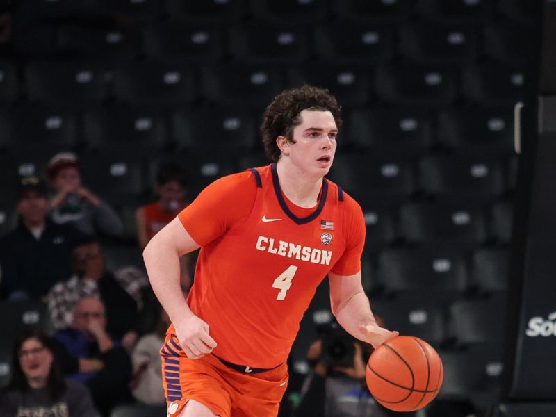 Jan 14, 2025; Atlanta, Georgia, USA; Clemson Tigers forward Ian Schieffelin (4) dribbles the ball up the court in the game against the Georgia Tech Yellow Jackets during the second half at McCamish Pavilion. Mandatory Credit: Jordan Godfree-Imagn Images