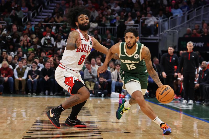 MILWAUKEE, WISCONSIN - DECEMBER 11: Cameron Payne #15 of the Milwaukee Bucks drives around Coby White #0 of the Chicago Bulls during a game at Fiserv Forum on December 11, 2023 in Milwaukee, Wisconsin. NOTE TO USER: User expressly acknowledges and agrees that, by downloading and or using this photograph, User is consenting to the terms and conditions of the Getty Images License Agreement. (Photo by Stacy Revere/Getty Images)