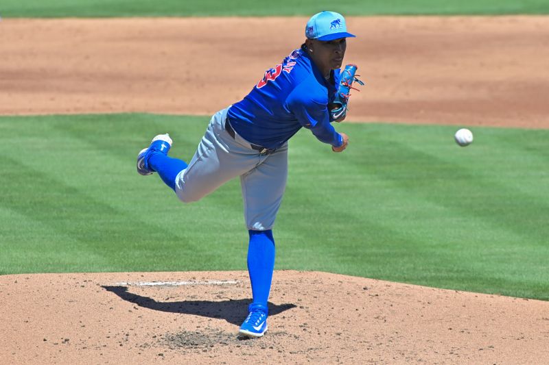 Mar 20, 2024; Mesa, Arizona, USA;  Chicago Cubs relief pitcher Adbert Alzolay (73) throws in the second inning against the Oakland Athletics during a spring training game at Hohokam Stadium. Mandatory Credit: Matt Kartozian-USA TODAY Sports