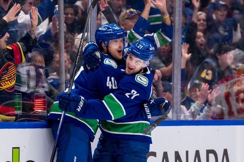 Apr 16, 2024; Vancouver, British Columbia, CAN;  Vancouver Canucks forward Elias Pettersson (40) and forward Nils Hoglander (21) celebrate Hoglander’s goal against the Calgary Flames in the first period at Rogers Arena. Mandatory Credit: Bob Frid-USA TODAY Sports