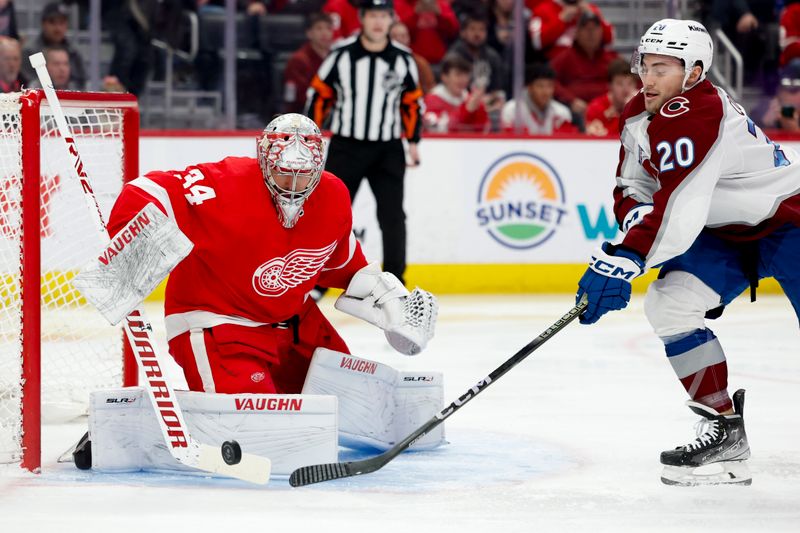 Feb 22, 2024; Detroit, Michigan, USA; Detroit Red Wings goaltender Alex Lyon (34) makes a save on Colorado Avalanche center Ross Colton (20) in the first period at Little Caesars Arena. Mandatory Credit: Rick Osentoski-USA TODAY Sports