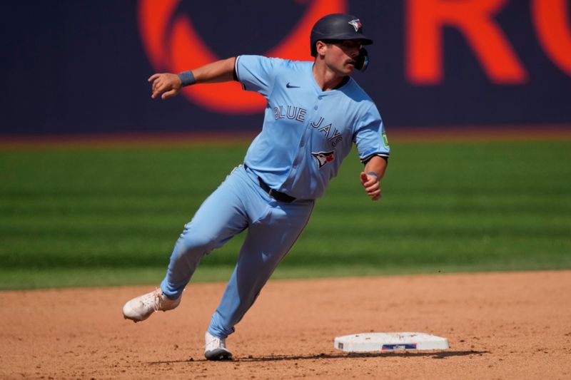 Jul 21, 2024; Toronto, Ontario, CAN; Toronto Blue Jays second baseman Davis Schneider (36) rounds second base after stealing on a passed ball against the Detroit Tigers during the eighth inning at Rogers Centre. Mandatory Credit: John E. Sokolowski-USA TODAY Sports