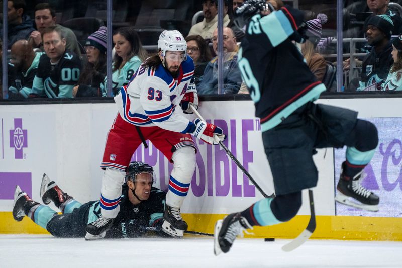 Nov 17, 2022; Seattle, Washington, USA; Seattle Kraken forward Jaden Schwartz (17) falls while battling for the puck with New York Rangers forward Mika Zibanejad (93) during the second period at Climate Pledge Arena. Mandatory Credit: Stephen Brashear-USA TODAY Sports