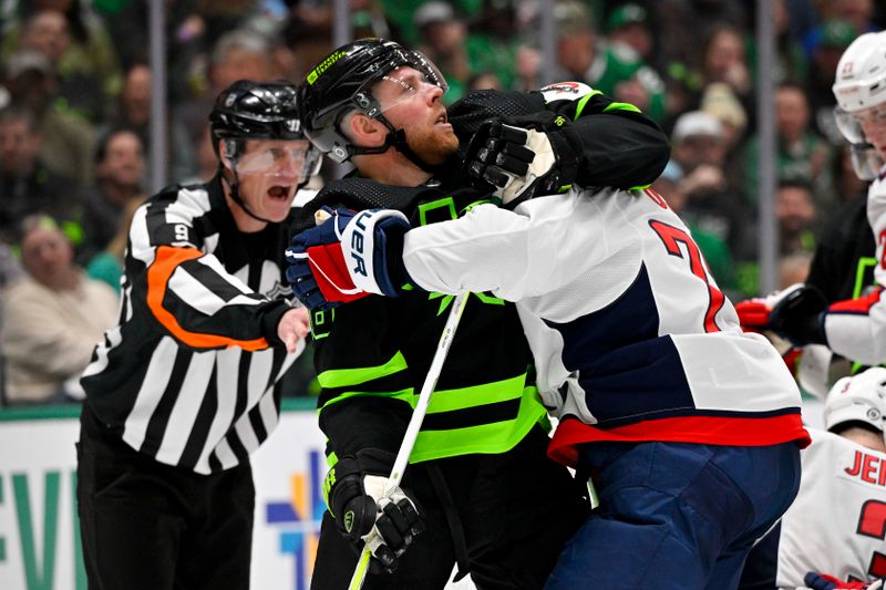 Jan 27, 2024; Dallas, Texas, USA; Washington Capitals right wing T.J. Oshie (77) grabs Dallas Stars center Joe Pavelski (16) in the Washington zone during the second period at the American Airlines Center. Mandatory Credit: Jerome Miron-USA TODAY Sports