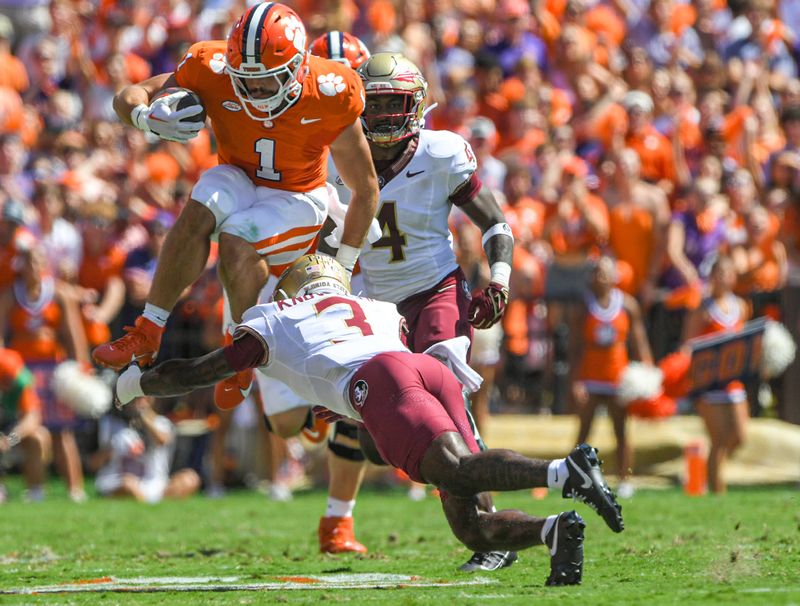 Sep 23, 2023; Clemson, South Carolina, USA; Clemson Tigers running back Will Shipley (1) jumps over Florida State Seminoles defensive back Kevin Knowles II (3) during the first quarter at Memorial Stadium. Mandatory Credit: Ken Ruinard-USA TODAY Sports