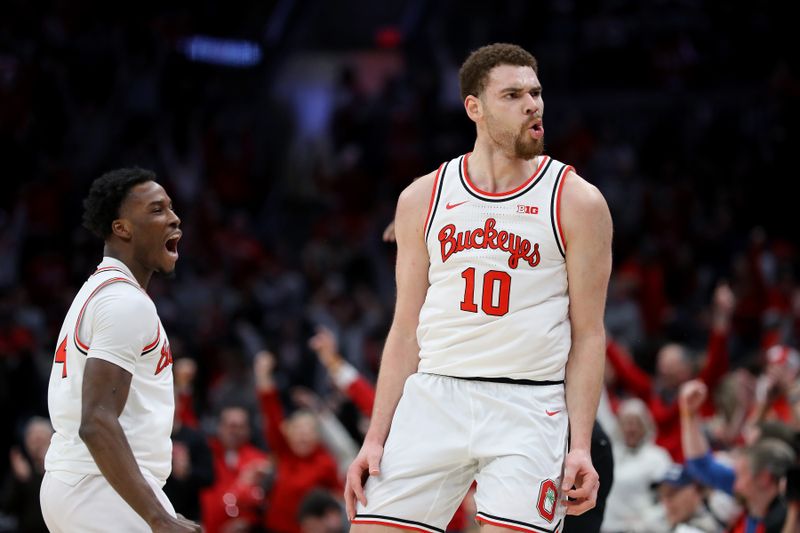 Feb 18, 2024; Columbus, Ohio, USA;  Ohio State Buckeyes forward Jamison Battle (10) celebrates with guard Dale Bonner (4) during the second half against the Purdue Boilermakers at Value City Arena. Mandatory Credit: Joseph Maiorana-USA TODAY Sports