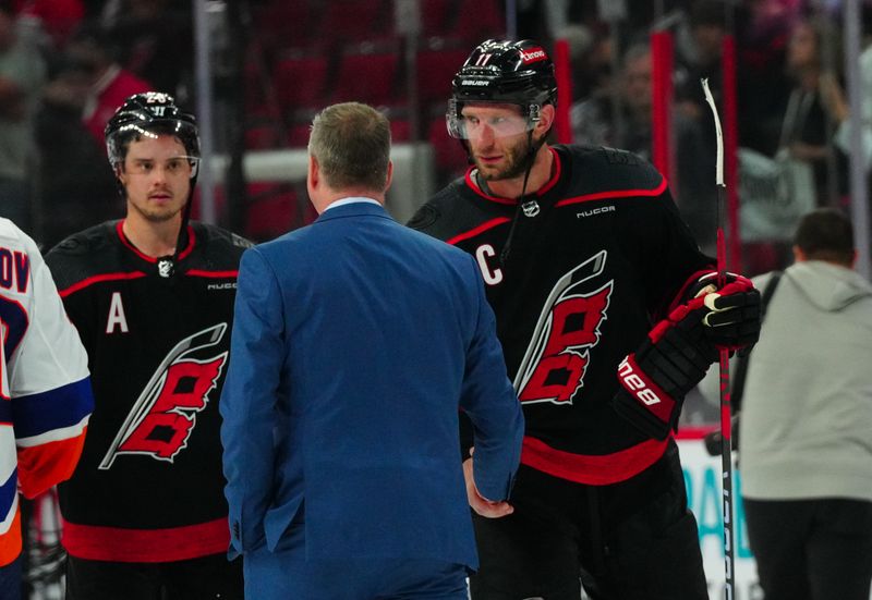 Apr 30, 2024; Raleigh, North Carolina, USA; Carolina Hurricanes center Jordan Staal (11) shakes hands with New York Islanders head coach Patrick Roy after the game in game five of the first round of the 2024 Stanley Cup Playoffs at PNC Arena. Mandatory Credit: James Guillory-USA TODAY Sports