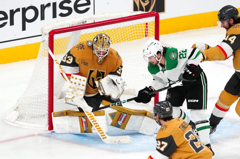 Dec 6, 2024; Las Vegas, Nevada, USA; Vegas Golden Knights goaltender Adin Hill (33) makes a save against a deflection by Dallas Stars center Mavrik Bourque (22) during the third period at T-Mobile Arena. Mandatory Credit: Stephen R. Sylvanie-Imagn Images