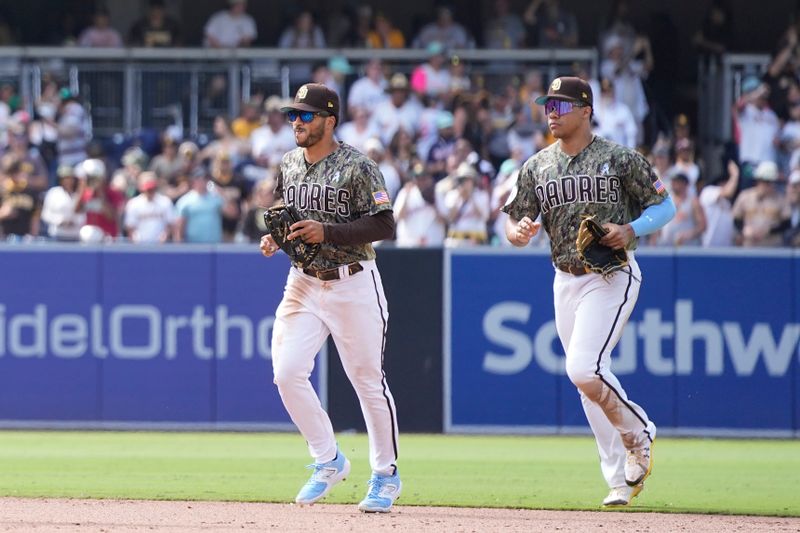 Jun 18, 2023; San Diego, California, USA;  San Diego Padres center fielder Trent Grisham (left) and left fielder Juan Soto (right) leave the field after defeating the Tampa Bay Rays at Petco Park. Mandatory Credit: Ray Acevedo-USA TODAY Sports