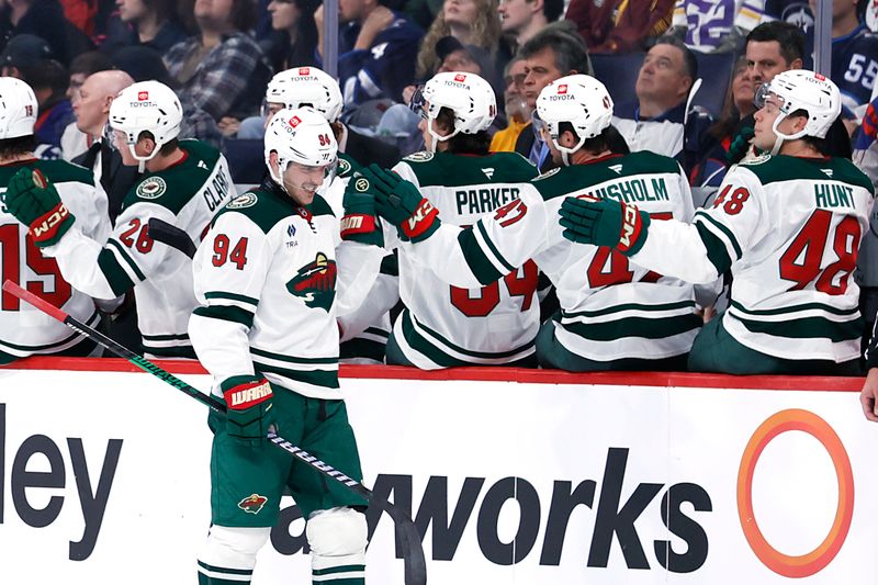 Sep 21, 2024; Winnipeg, Manitoba, CAN; Minnesota Wild center Jakub Lauko (94) celebrates his second period goal against the Winnipeg Jets at Canada Life Centre. Mandatory Credit: James Carey Lauder-Imagn Images