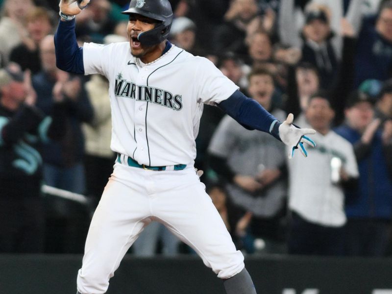 Apr 15, 2023; Seattle, Washington, USA; Seattle Mariners center fielder Julio Rodriguez (44) celebrates at third base after hitting a 3-RBI triple against the Colorado Rockies during the fourth inning at T-Mobile Park. Mandatory Credit: Steven Bisig-USA TODAY Sports