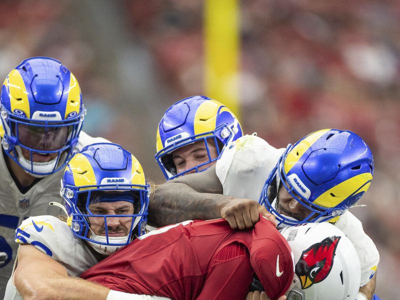 Arizona Cardinals running back James Conner (6) is tackled by the Los Angeles Rams in an NFL football game, Sunday, Sept. 15, 2024, in Glendale, Ariz. Cardinals defeated the Rams 41-10. (AP Photo/Jeff Lewis)