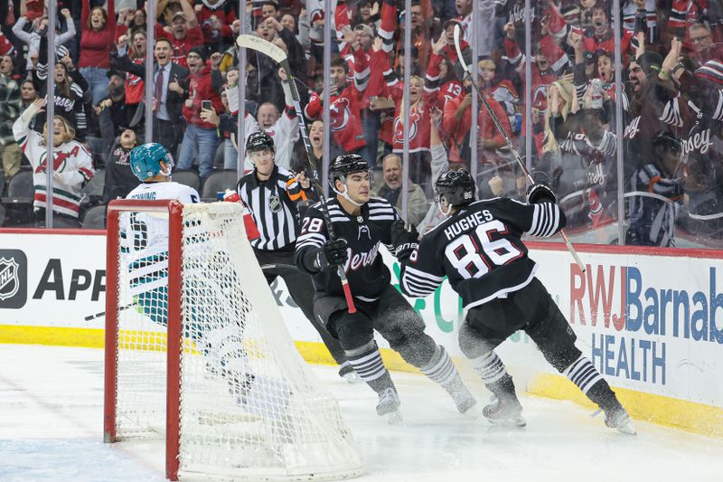 Dec 1, 2023; Newark, New Jersey, USA; New Jersey Devils center Jack Hughes (86) celebrates with right wing Timo Meier (28) after scoring a goal against the San Jose Sharks during the third period at Prudential Center. Mandatory Credit: Vincent Carchietta-USA TODAY Sports