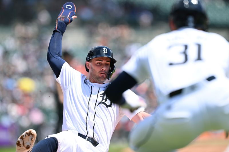 Jun 13, 2024; Detroit, Michigan, USA;  Detroit Tigers shortstop Ryan Kreidler (32) slides safely into home plate to score a run against the Washington Nationals in the third inning at Comerica Park. Mandatory Credit: Lon Horwedel-USA TODAY Sports