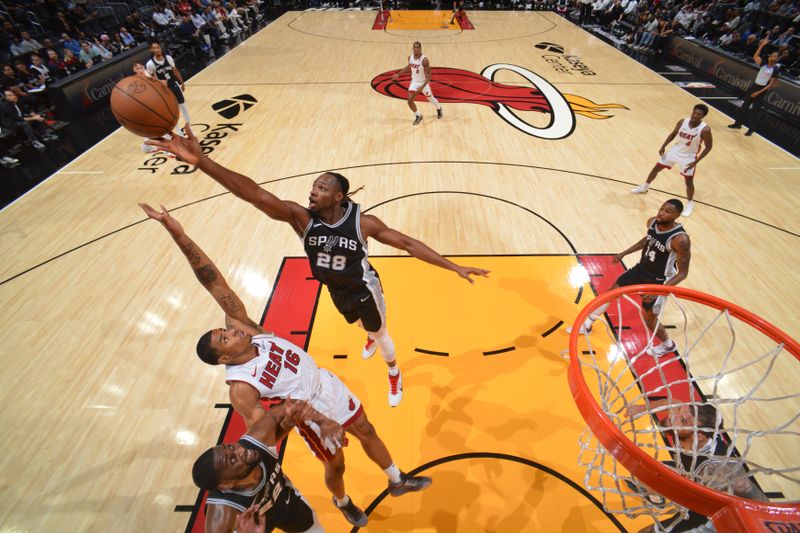 MIAMI, FL - OCTOBER 15: Charles Bassey #28 of the San Antonio Spurs rebounds the ball during the game against the Miami Heat during a NBA preseason game on October 15, 2024 at Kaseya Center in Miami, Florida. NOTE TO USER: User expressly acknowledges and agrees that, by downloading and or using this Photograph, user is consenting to the terms and conditions of the Getty Images License Agreement. Mandatory Copyright Notice: Copyright 2024 NBAE (Photo by Jesse D. Garrabrant/NBAE via Getty Images)