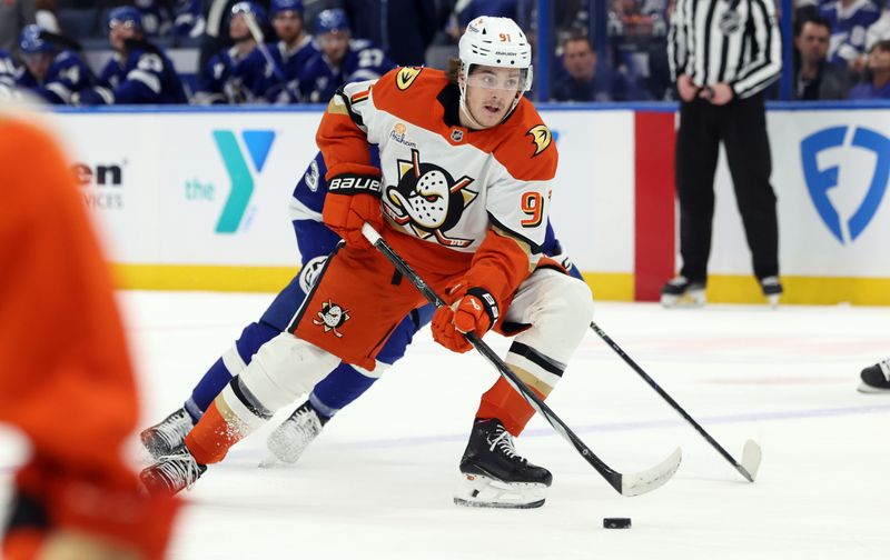 Jan 16, 2025; Tampa, Florida, USA; Anaheim Ducks center Leo Carlsson (91) skate with the puck as Tampa Bay Lightning defenseman Darren Raddysh (43) defends during the second period at Amalie Arena. Mandatory Credit: Kim Klement Neitzel-Imagn Images