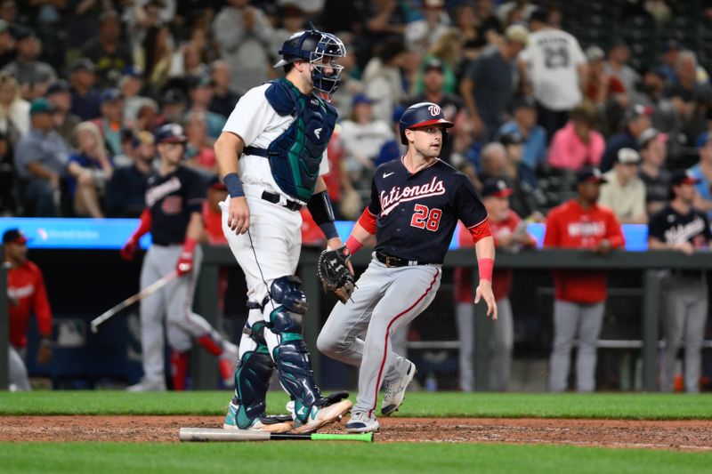 Jun 27, 2023; Seattle, Washington, USA; Washington Nationals right fielder Lane Thomas (28) scores a run off a single hit by second baseman Luis Garcia (not pictured) during the eleventh inning at T-Mobile Park. Mandatory Credit: Steven Bisig-USA TODAY Sports