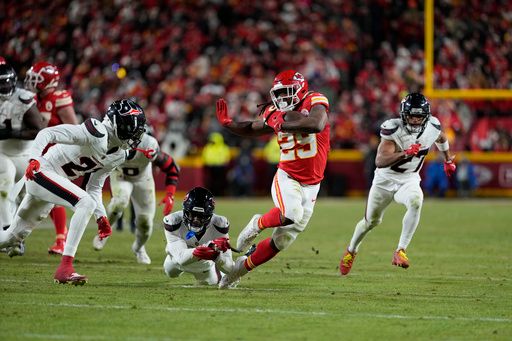 Kansas City Chiefs running back Kareem Hunt (29) runs with the ball for a first down during the second half of an NFL football AFC divisional playoff game against the Houston Texans Saturday, Jan. 18, 2025, in Kansas City, Mo. (AP Photo/Ed Zurga)